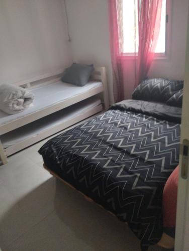 a small bedroom with a bed and a window at דירת אירוח בקצרין in Qasrîne
