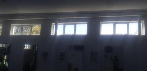 a room with three windows in a dark room at MARANATHA ACCOMMODATION in Cape Town