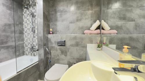 a bathroom with a sink and a toilet and a tub at Private Studio Burj Khalifa Area -BEST PRICE in Dubai