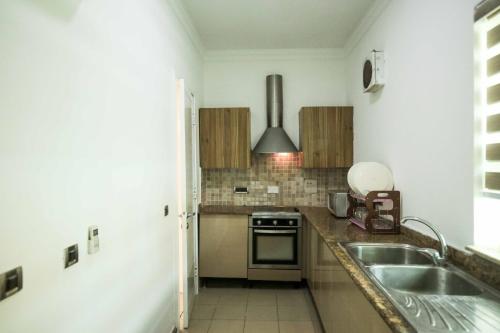 a kitchen with a sink and a stove at LJ's Place in Lagos