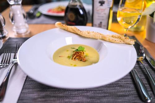 a plate of soup and a piece of bread on a table at Quality Hotel Brno Exhibition Centre in Brno