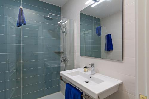 a bathroom with a sink and a shower with a mirror at Apartamentos Panorama Adults Only in Puerto del Carmen