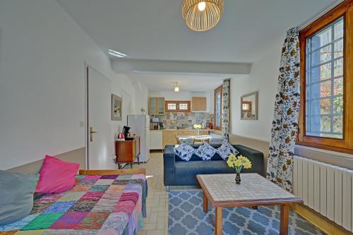 a living room with a couch and a table at Les Rosiers in Luchon