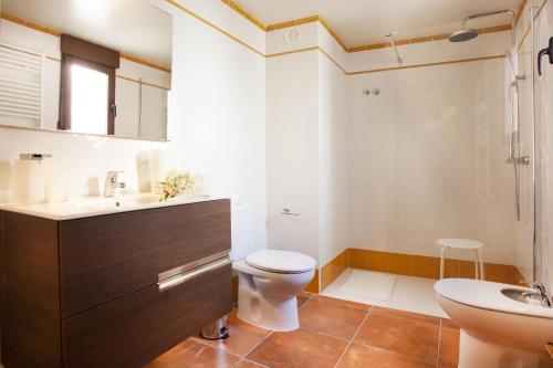 a bathroom with a toilet and a sink at El Rincon De Jara in Caudiel