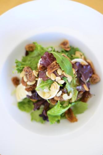 a salad with nuts on a white plate at Herdade Do Touril in Zambujeira do Mar
