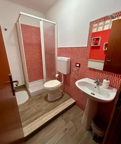 a bathroom with a toilet and a shower and a sink at Albergo Mendolia in Milazzo