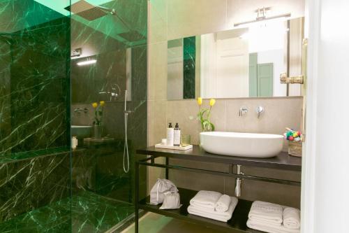 a bathroom with a sink and a mirror at Family Affair Luxury Rooms&Suites in Palermo