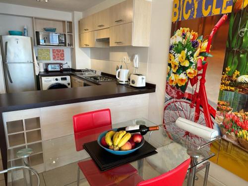 a kitchen with a bowl of fruit on a table at Playa La Herradura - La Serena in Coquimbo