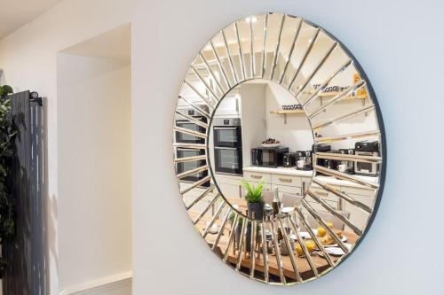 a mirror in a kitchen with a spiral staircase at Luxurious 3 Bedroom Apartment in Park Estate in Nottingham