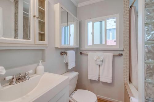 a white bathroom with a sink and a toilet at Ocean Beach Cottage in San Diego
