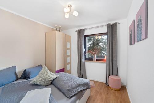 a living room with a couch and a window at ANYTIME - Ferienwohnung Tina in Friedrichshafen am Bodensee in Friedrichshafen