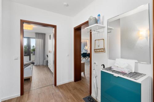 a kitchen with a blue counter in a room at ANYTIME - Ferienwohnung Tina in Friedrichshafen am Bodensee in Friedrichshafen