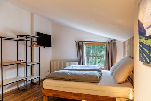 a bedroom with a bed and a window at Appartement by Blahut Vacation - dg in Ehrwald