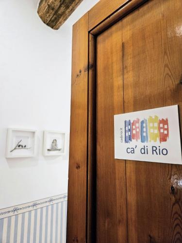 a sign on a wooden door in a room at ca' di Rio in Riomaggiore