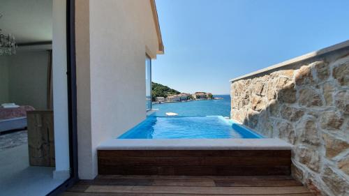 a swimming pool with a view of the water at Guesthouse Augusta Insula in Lastovo