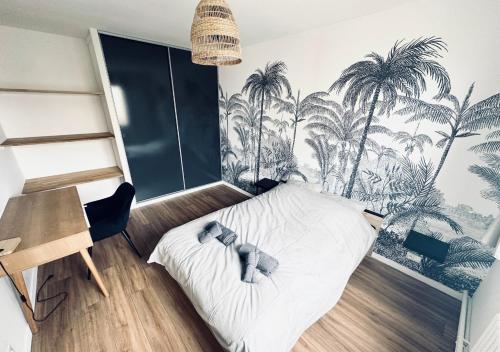 a bedroom with a bed with palm trees on the wall at Superbe T5 moderne à 10 min de Lille-Centre in Loos