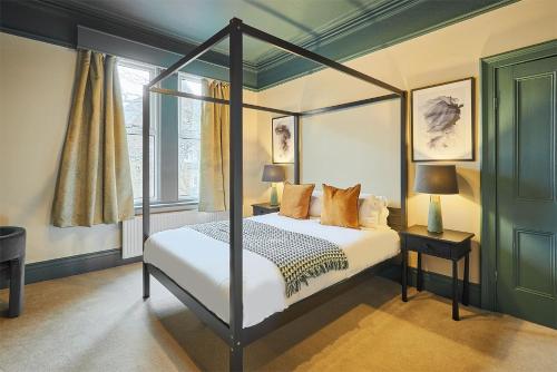 a bedroom with a four poster bed and a window at Host & Stay - Kittiwake House in Whitley Bay