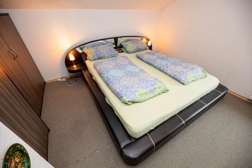a bedroom with two beds in a small room at Haus am Wald in Bad Koetzting