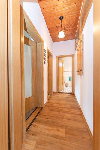 a hallway with wood floors and a ceiling at Haus am Wald in Bad Koetzting