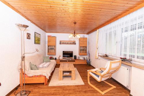 a living room with a couch and a table at Haus am Wald in Bad Koetzting