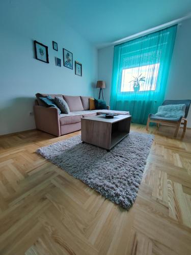 a living room with a couch and a coffee table at Krstić_lux apartman in Subotica