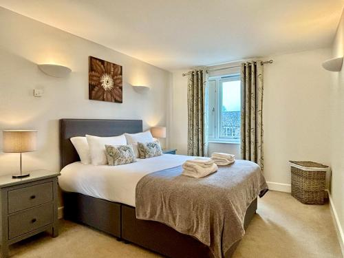 a bedroom with a large bed with a window at Your Space Apartments - The Hamilton's in Cambridge