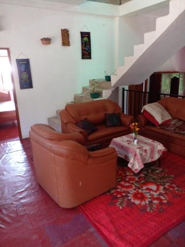 a living room with a couch and a table at Green View In Nuwaraeliya in Nuwara Eliya