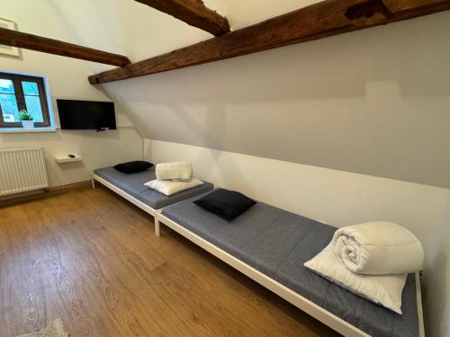 a bedroom with two beds in the corner of a room at V Údolí in Jablonné v Podještědí