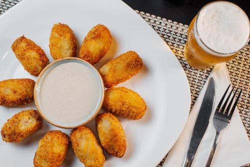 a plate of food with a glass of beer at ibis Styles Goiânia Shopping Estação in Goiânia