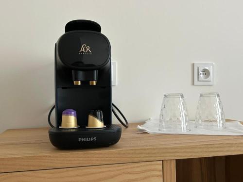 a black coffee maker sitting on top of a table at Chrobry pokój de luxe in Gorzów Wielkopolski