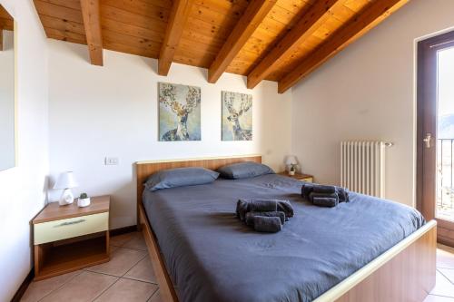a bedroom with a large bed with blue sheets at LAGO DI COMO - Luxury Panoramic Garden - Free Wifi in Gera Lario