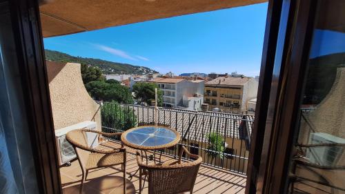 a balcony with a table and chairs and a view at La Font Lovely apartment LEstartit 400 meter from the beach in L'Estartit