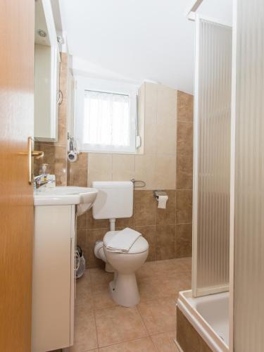 a bathroom with a toilet and a sink and a shower at Villa Valentina in Zadar
