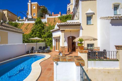 a villa with a swimming pool and a house at Nerja Villas Tamango Hill 5 Silhouse in Torrox