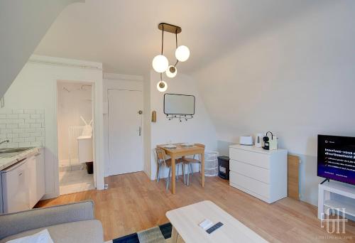 ein Wohnzimmer mit einem Tisch und einem Esszimmer in der Unterkunft Le Scandinave in Tours