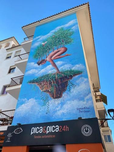 a billboard with a person on a tree on a island at Casa Desire in Estepona