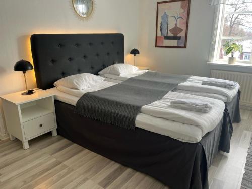 a bedroom with a large bed and a night stand at Annexet Kilafors in Kilafors