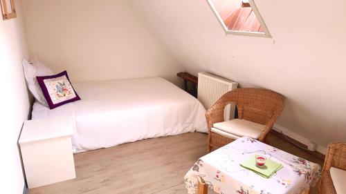 Vinaring Homestay في باد سوبرنهيم: غرفة نوم صغيرة بها سرير وكرسي