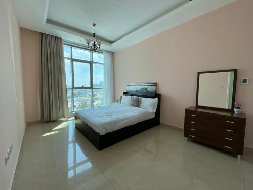 um quarto com uma cama, um espelho e uma cómoda em Luxurious Sea View - Beach Front em Ajman