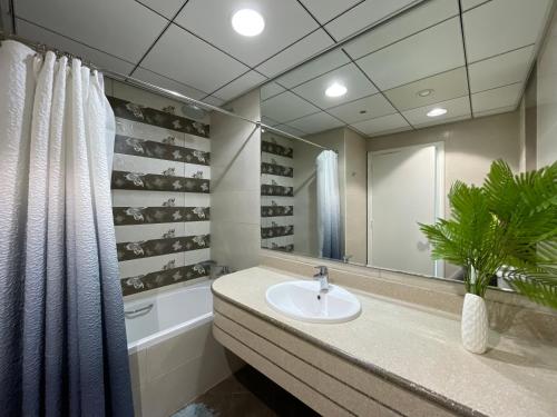 a bathroom with a sink and a mirror at Luxurious Sea View - Beach Front in Ajman 