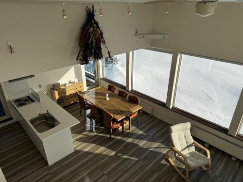 a kitchen and dining room with a table and chairs at Mountain Villa ニセコ in Kutchan