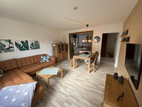 a living room with a couch and a table at Fewo Am Edersee in Hemfurth-Edersee