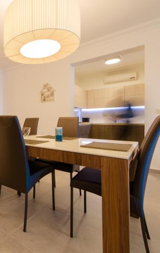 a conference room with a wooden table and chairs at Seafront Apartment Sliema in Sliema