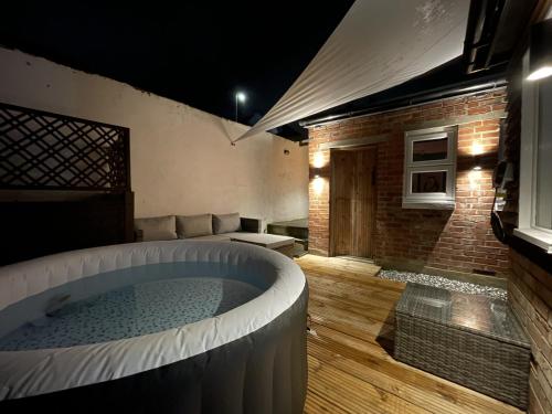 a room with a hot tub in the middle of a room at Coastal Comfort, Hot Tub Lodge in Margate