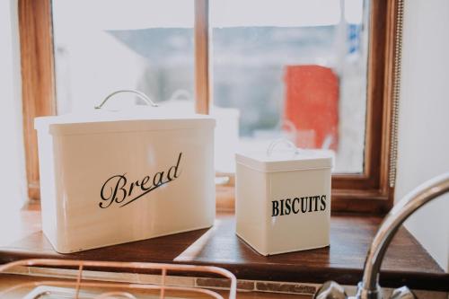 two white baskets sitting on a counter next to a sink at Pattys Barn Holiday Cottages, Cabins and Venue Hire in Cockerham