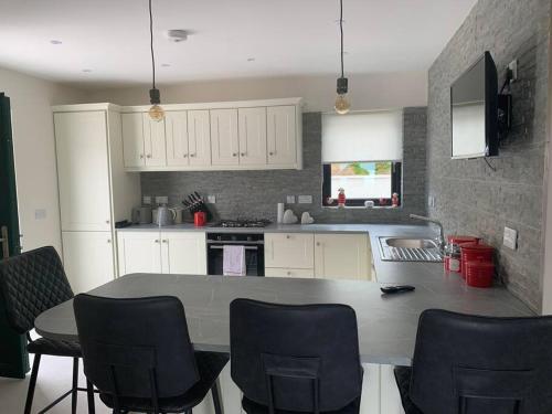 a kitchen with a table and chairs in it at Kells Bay Apartment in Kells