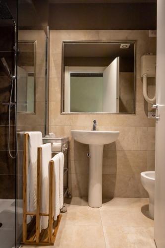 a bathroom with a sink and a mirror at Hotel Milano Pool & Garden in Salice Terme