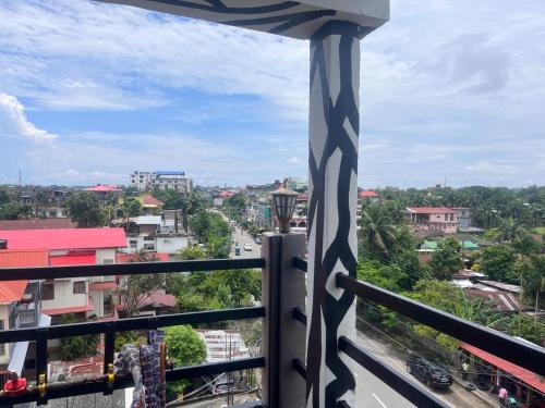 a balcony with a view of a city at HOTEL AARNA in Tezpur