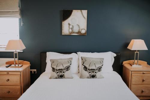 a bedroom with a bed with two skulls on the pillows at Pattys Barn Holiday Cottages, Cabins and Venue Hire in Cockerham