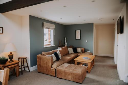a living room with a couch and a table at Pattys Barn Holiday Cottages, Cabins and Venue Hire in Cockerham